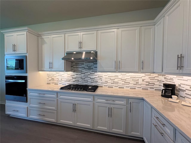 8243 Fenton St, Orlando, FL 32836 - kitchen featuring oven, stainless steel gas stovetop, under cabinet range hood, built in microwave, and backsplash