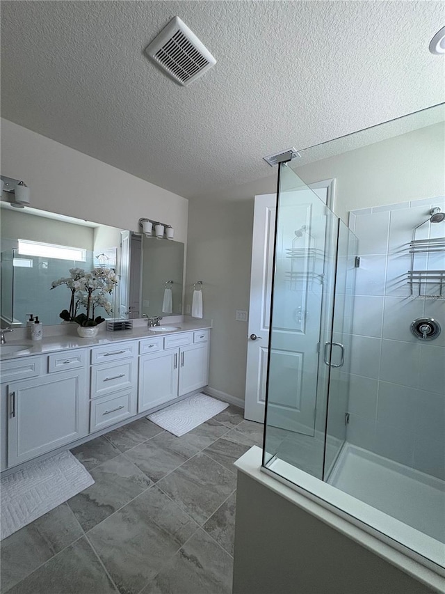 8243 Fenton St, Orlando, FL 32836 - bathroom featuring double vanity, a stall shower, and a textured ceiling