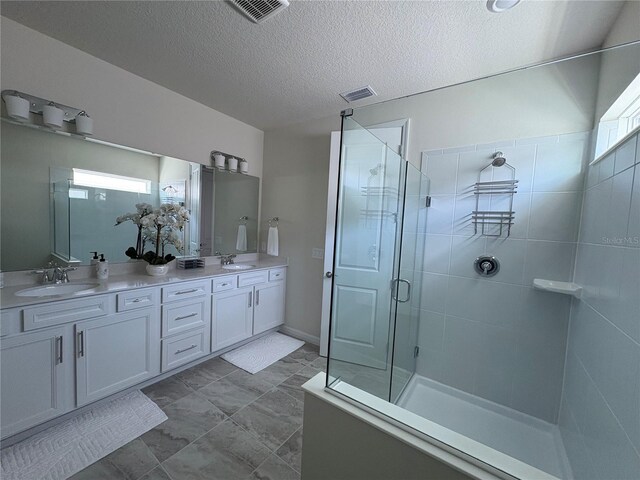 8243 Fenton St, Orlando, FL 32836 - bathroom with a shower stall, double vanity, and a textured ceiling