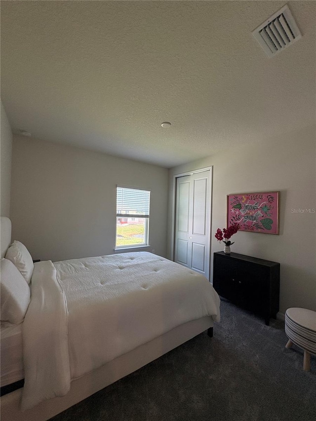 8243 Fenton St, Orlando, FL 32836 - bedroom with carpet floors, a closet, and a textured ceiling