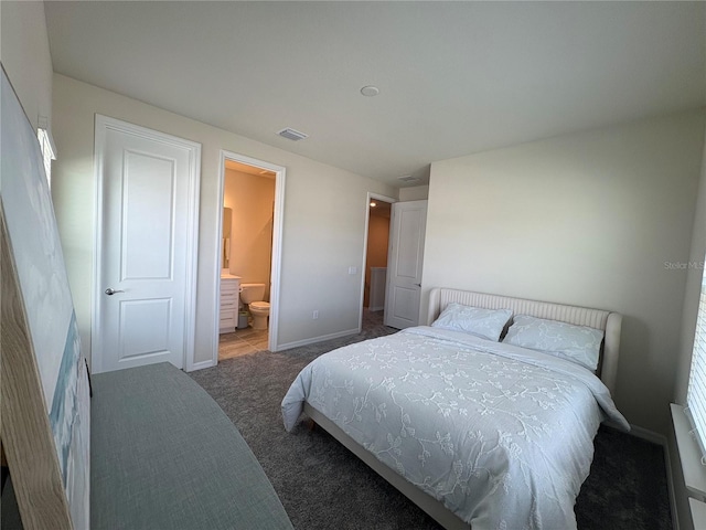 8243 Fenton St, Orlando, FL 32836 - carpeted bedroom with baseboards and ensuite bathroom