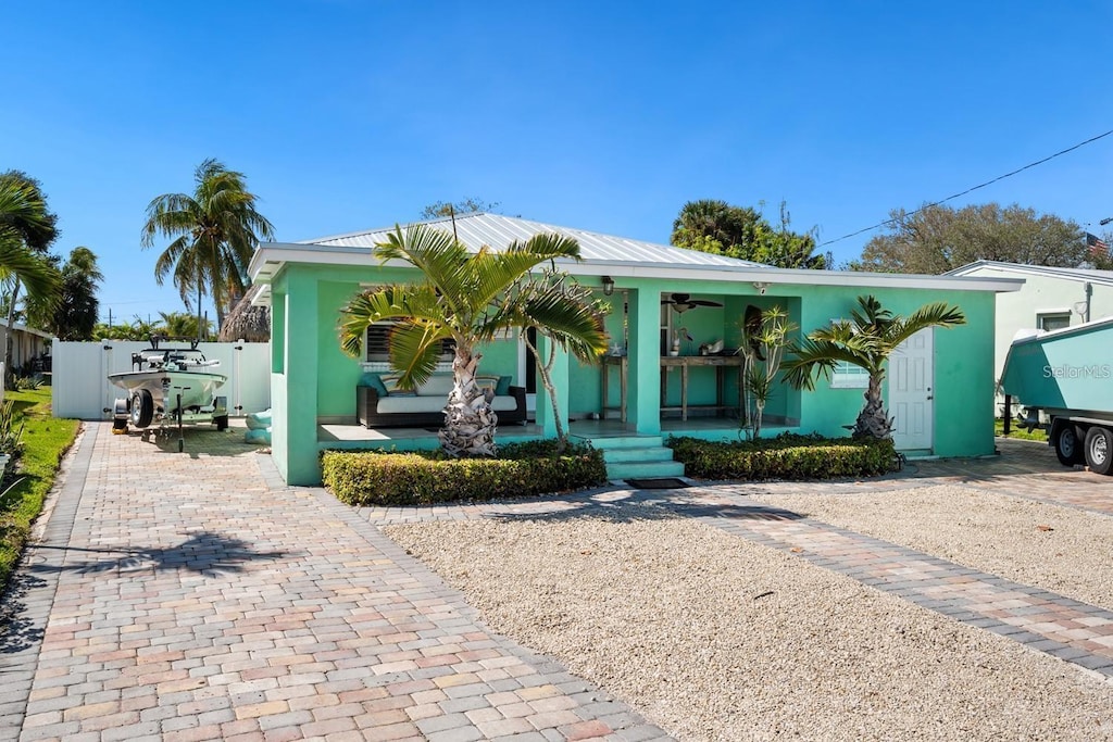 107 Eldorado St, Fort Pierce, FL 34949 - view of front of house featuring fence, ceiling fan, stucco siding, and a porch