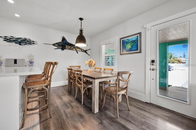 dining space featuring recessed lighting, baseboards, and wood finished floors