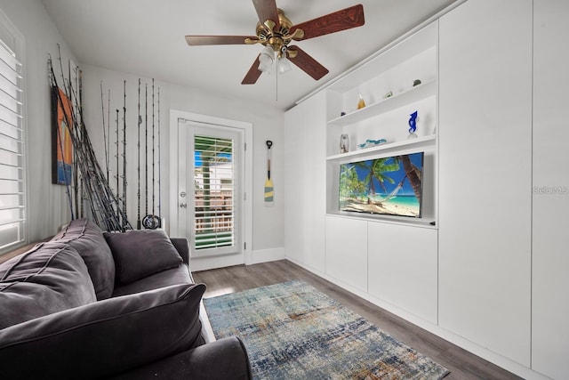 living room with ceiling fan and wood finished floors