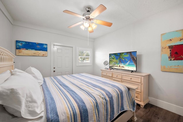 bedroom featuring dark wood-type flooring, ceiling fan, and baseboards