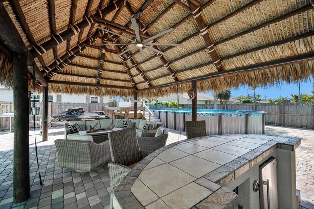 view of patio with fence, a fenced in pool, outdoor dining area, a gazebo, and outdoor lounge area