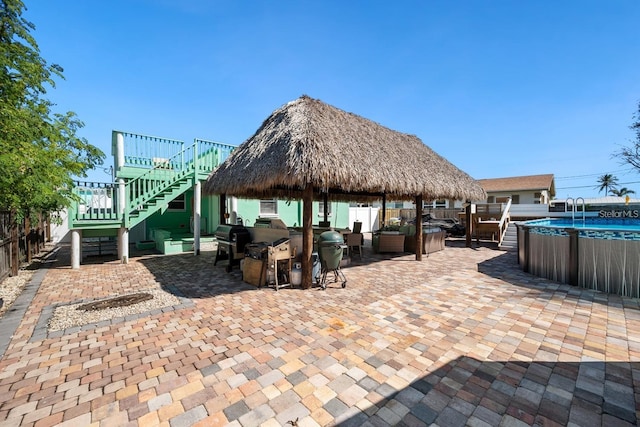 view of patio with stairs, a gazebo, area for grilling, and fence