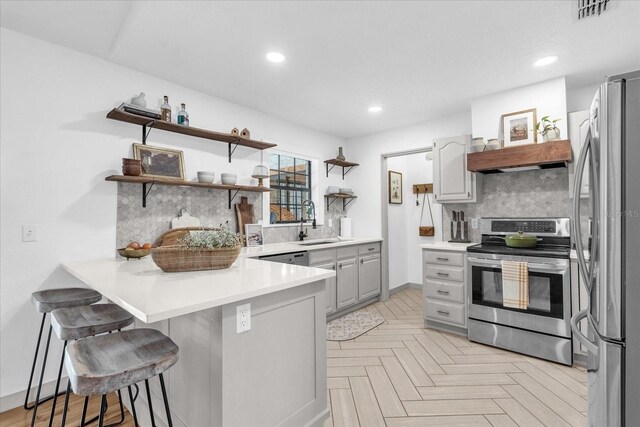 1558 Regal Oak Dr, Kissimmee, FL 34744 - kitchen with open shelves, a sink, stainless steel appliances, a peninsula, and visible vents