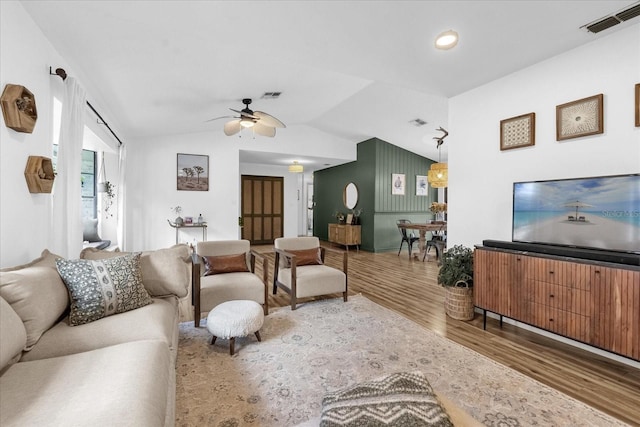 1558 Regal Oak Dr, Kissimmee, FL 34744 - living room featuring visible vents, ceiling fan, wood finished floors, and vaulted ceiling