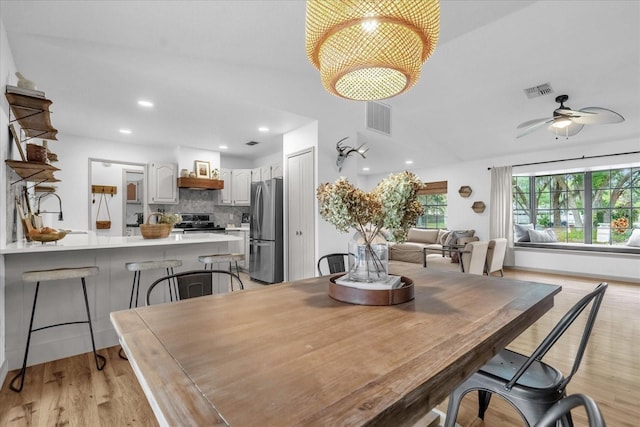 1558 Regal Oak Dr, Kissimmee, FL 34744 - dining area with visible vents, recessed lighting, light wood-style floors, and ceiling fan