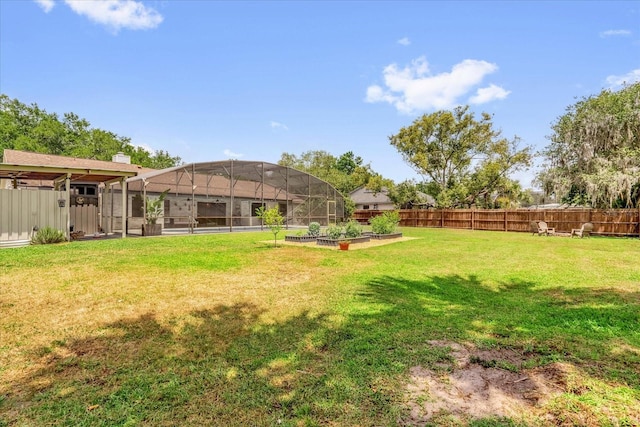 1558 Regal Oak Dr, Kissimmee, FL 34744 - view of yard featuring a fenced backyard, a lanai, and a garden