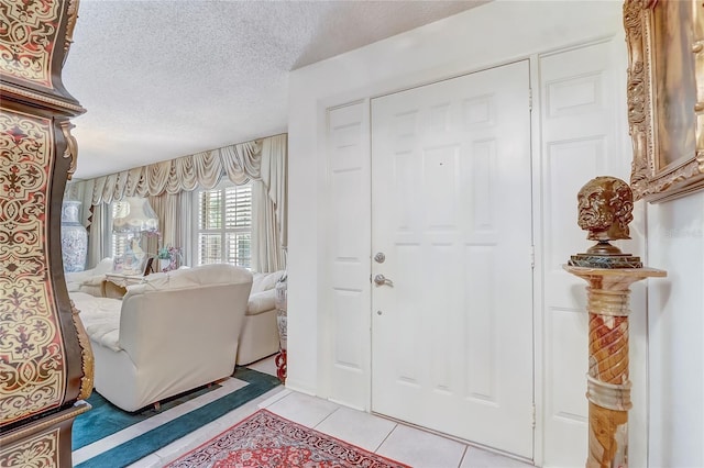 entrance foyer featuring light tile patterned flooring and a textured ceiling