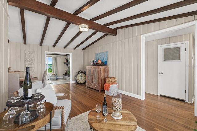 living room featuring lofted ceiling with beams and wood finished floors