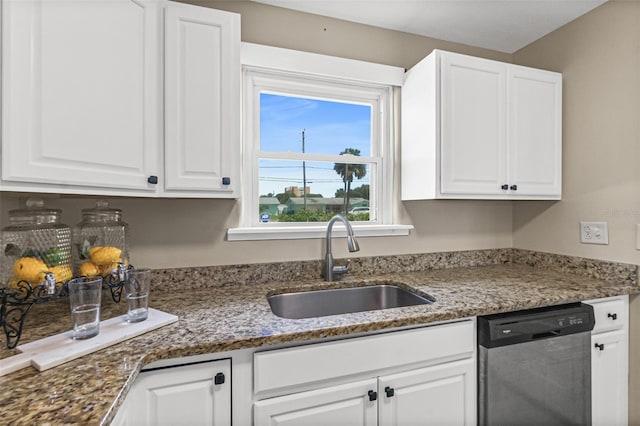 kitchen with white cabinetry, a sink, stone counters, and stainless steel dishwasher