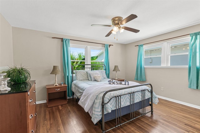 bedroom with baseboards, ceiling fan, and wood finished floors