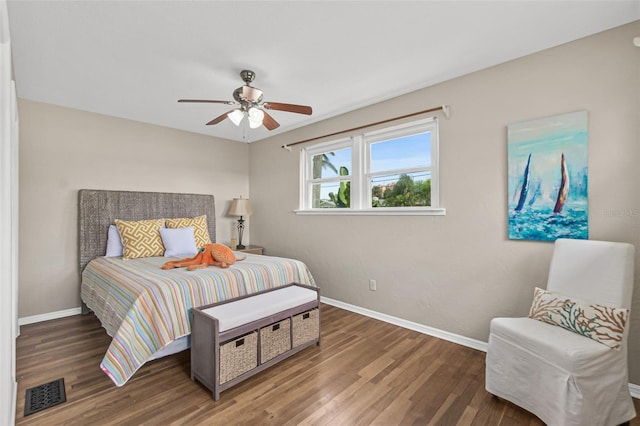 bedroom featuring a ceiling fan, wood finished floors, baseboards, and visible vents