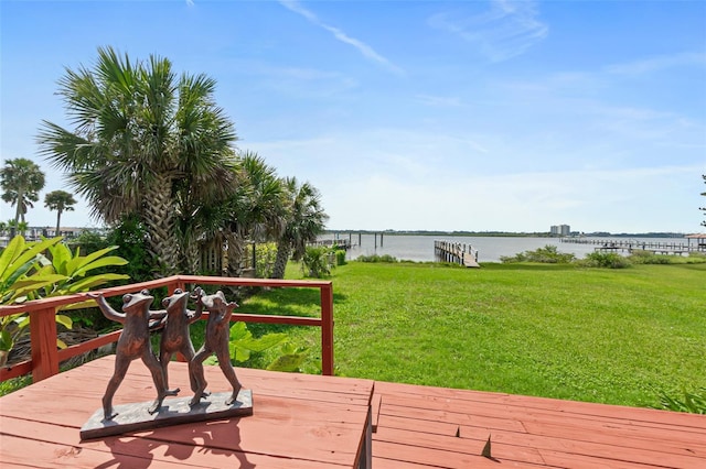 deck with a water view and a yard