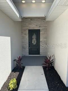 entrance to property featuring stucco siding