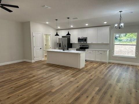 kitchen with open floor plan, appliances with stainless steel finishes, and recessed lighting