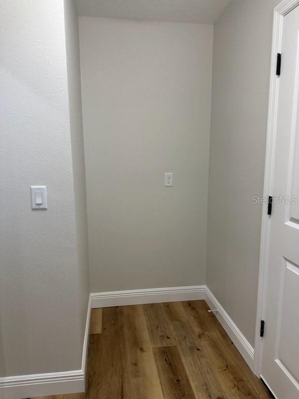 interior space featuring light wood-style flooring and baseboards