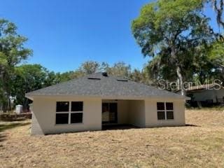 rear view of property with stucco siding