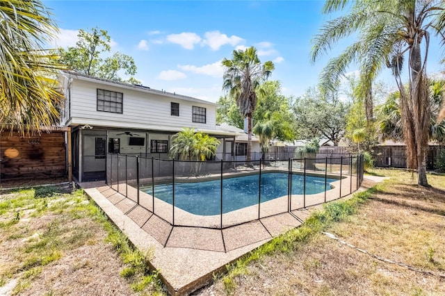 view of pool with a fenced backyard, a fenced in pool, and ceiling fan