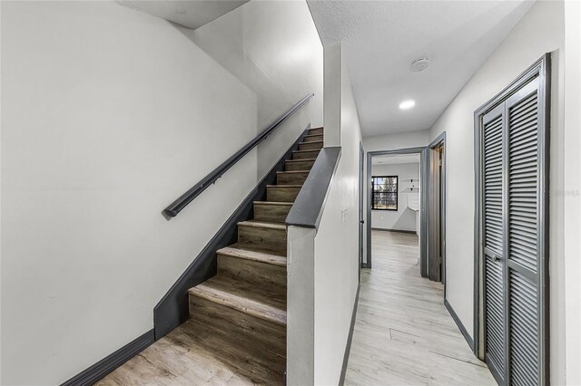 stairs with baseboards and wood finished floors