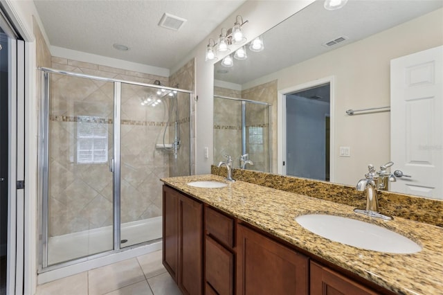 8639 Lower Villagewalk Cir, Orlando, FL 32827 - full bath with double vanity, a stall shower, tile patterned floors, and a textured ceiling