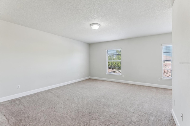 8639 Lower Villagewalk Cir, Orlando, FL 32827 - empty room featuring light carpet, a textured ceiling, and baseboards