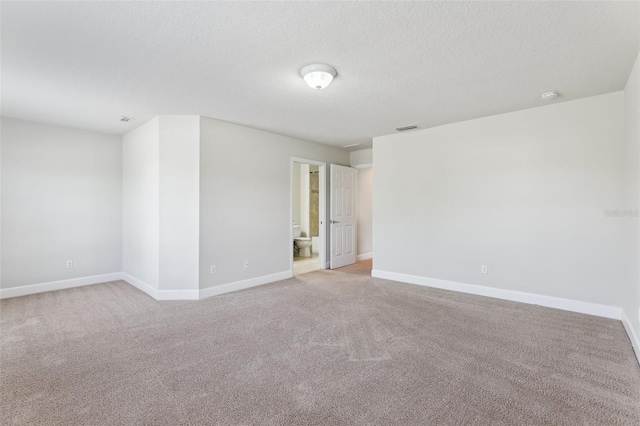 8639 Lower Villagewalk Cir, Orlando, FL 32827 - unfurnished room with light colored carpet, baseboards, a textured ceiling, and a smoke detector