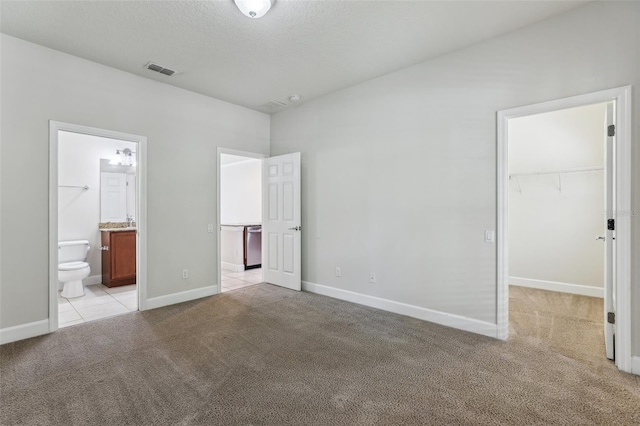 8639 Lower Villagewalk Cir, Orlando, FL 32827 - unfurnished bedroom with light carpet, a walk in closet, baseboards, and a closet