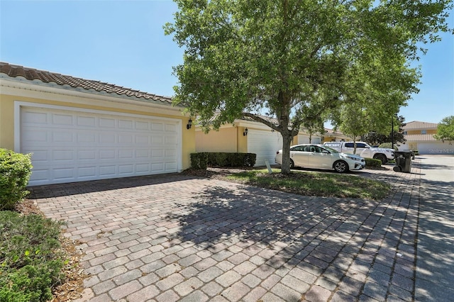 8639 Lower Villagewalk Cir, Orlando, FL 32827 - view of front of house featuring decorative driveway and stucco siding