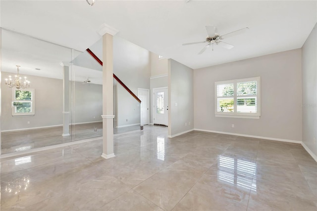 12706 Magnolia Bay Blvd, Clermont, FL 34711 - empty room featuring a ceiling fan, healthy amount of natural light, a chandelier, and ornate columns
