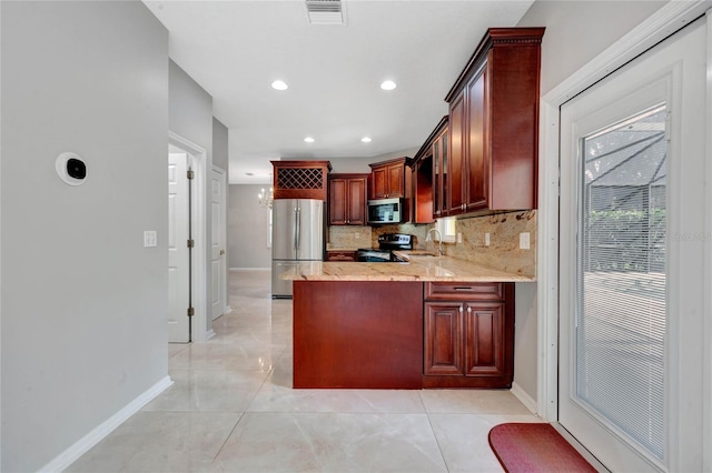 12706 Magnolia Bay Blvd, Clermont, FL 34711 - kitchen featuring stainless steel appliances, light stone countertops, backsplash, a peninsula, and light tile patterned flooring
