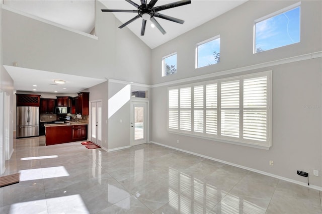 12706 Magnolia Bay Blvd, Clermont, FL 34711 - unfurnished living room with high vaulted ceiling, a ceiling fan, and light marble finish floors