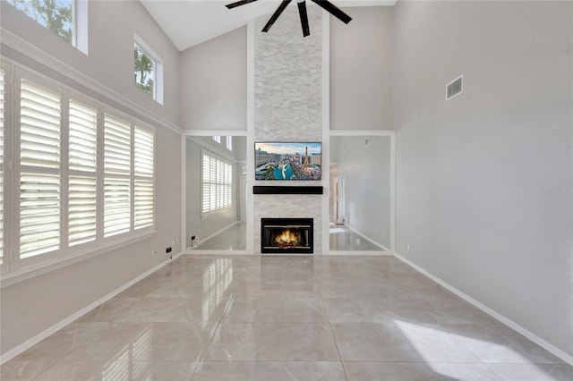 12706 Magnolia Bay Blvd, Clermont, FL 34711 - unfurnished living room with high vaulted ceiling, ceiling fan, and a fireplace