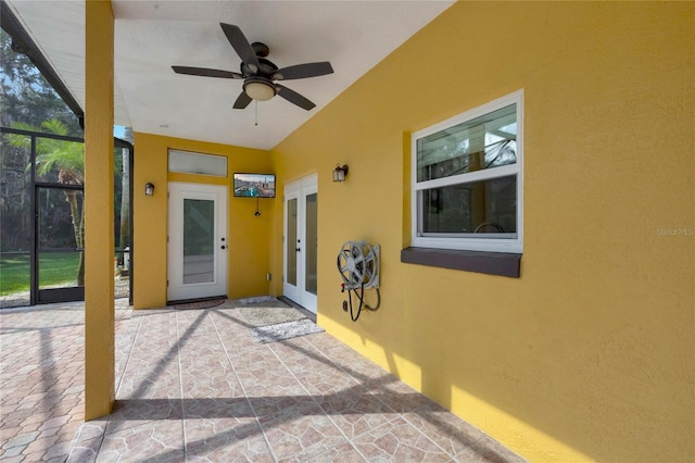 12706 Magnolia Bay Blvd, Clermont, FL 34711 - property entrance featuring stucco siding, ceiling fan, a patio, and french doors