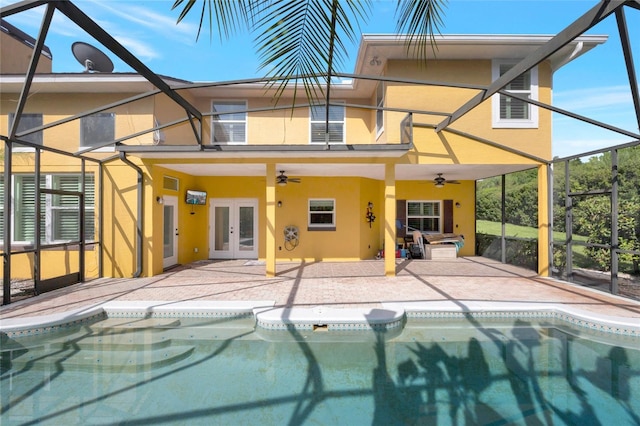 12706 Magnolia Bay Blvd, Clermont, FL 34711 - rear view of property featuring stucco siding, french doors, a ceiling fan, a patio area, and glass enclosure