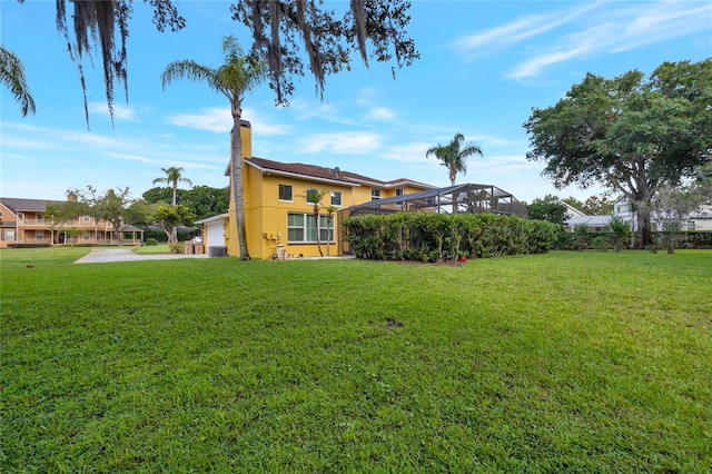 12706 Magnolia Bay Blvd, Clermont, FL 34711 - rear view of property featuring a chimney, a yard, and stucco siding