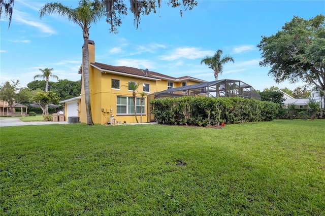 12706 Magnolia Bay Blvd, Clermont, FL 34711 - back of property featuring stucco siding, a chimney, and a lawn