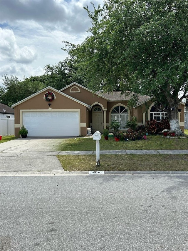 8330 Sun Vista Way, Orlando, FL 32822 - ranch-style home featuring driveway, stucco siding, and an attached garage