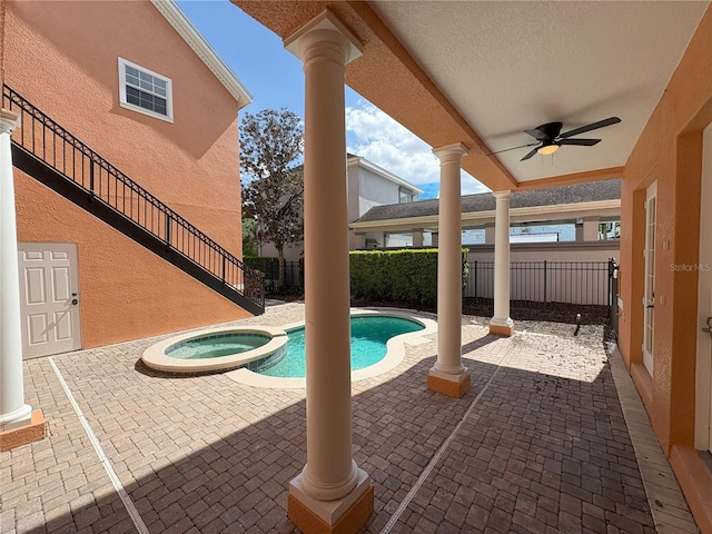 view of swimming pool with a patio area, a pool with connected hot tub, a fenced backyard, and ceiling fan