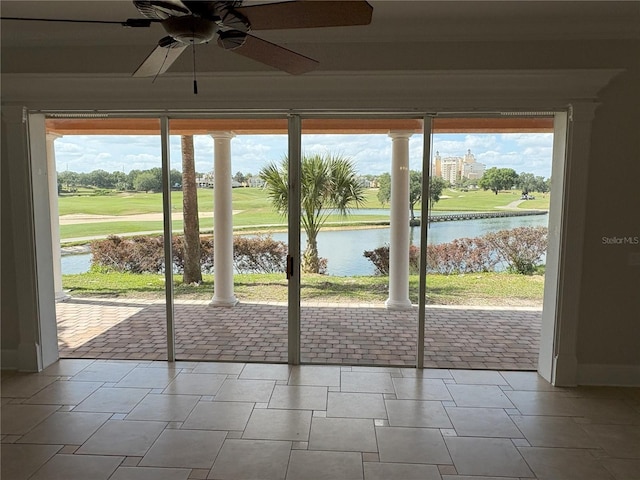 doorway to outside featuring a water view and a ceiling fan