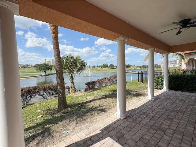 view of patio / terrace with a water view and a ceiling fan