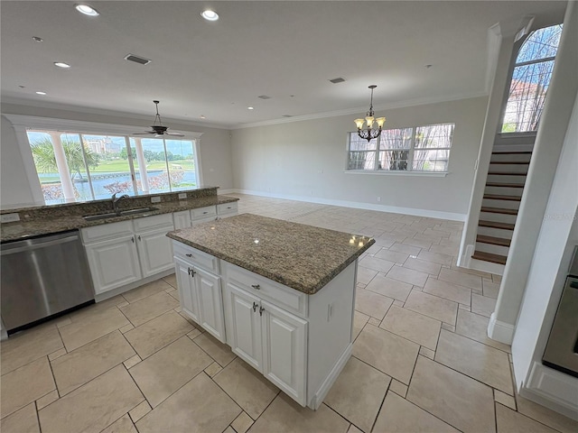 kitchen featuring ceiling fan with notable chandelier, stainless steel dishwasher, ornamental molding, white cabinets, and a sink