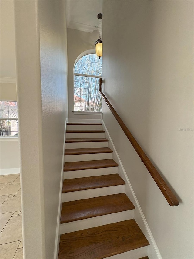 staircase with ornamental molding