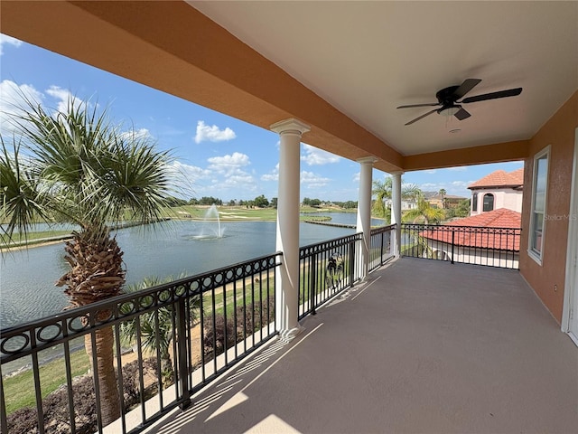 balcony featuring ceiling fan and a water view