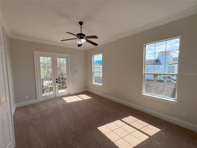 carpeted empty room with french doors, ornamental molding, baseboards, and ceiling fan