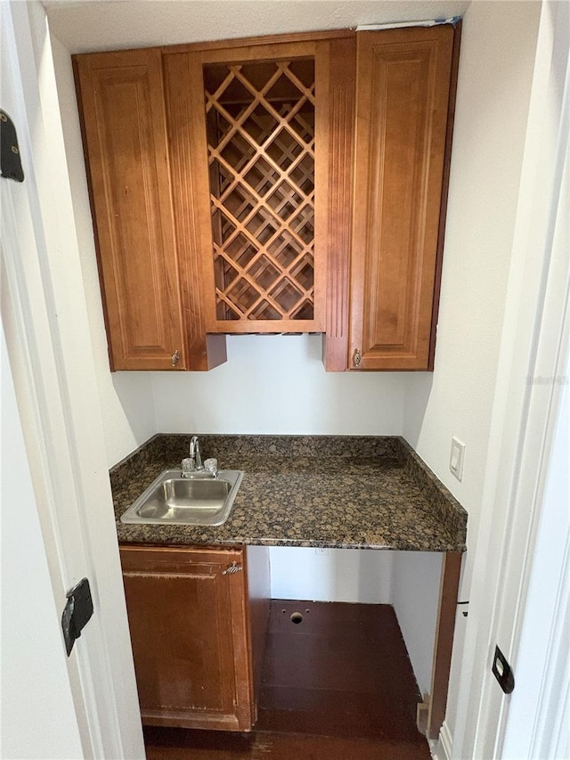 kitchen featuring brown cabinetry and a sink