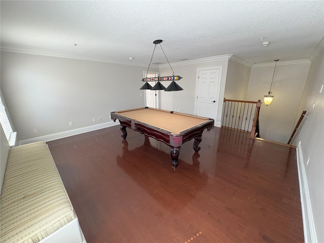 recreation room featuring baseboards, ornamental molding, and wood finished floors
